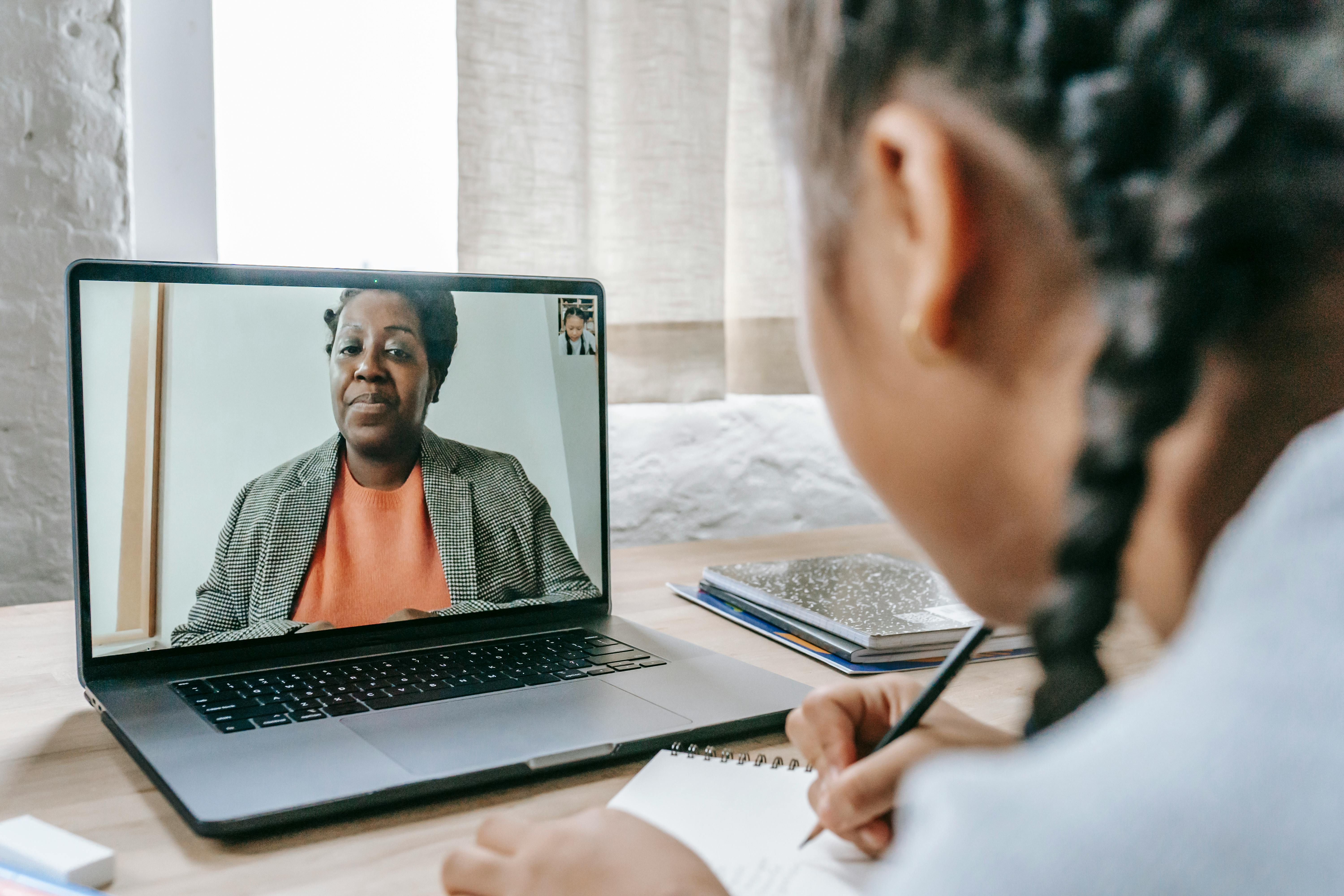 Student learning online with laptop and notes